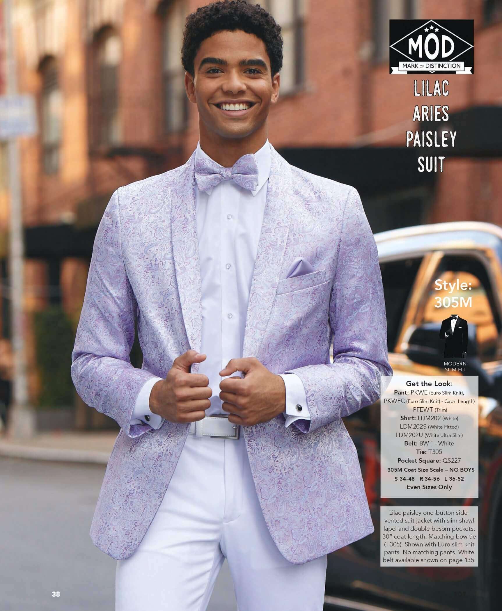 Man in lilac paisley suit smiling outside.