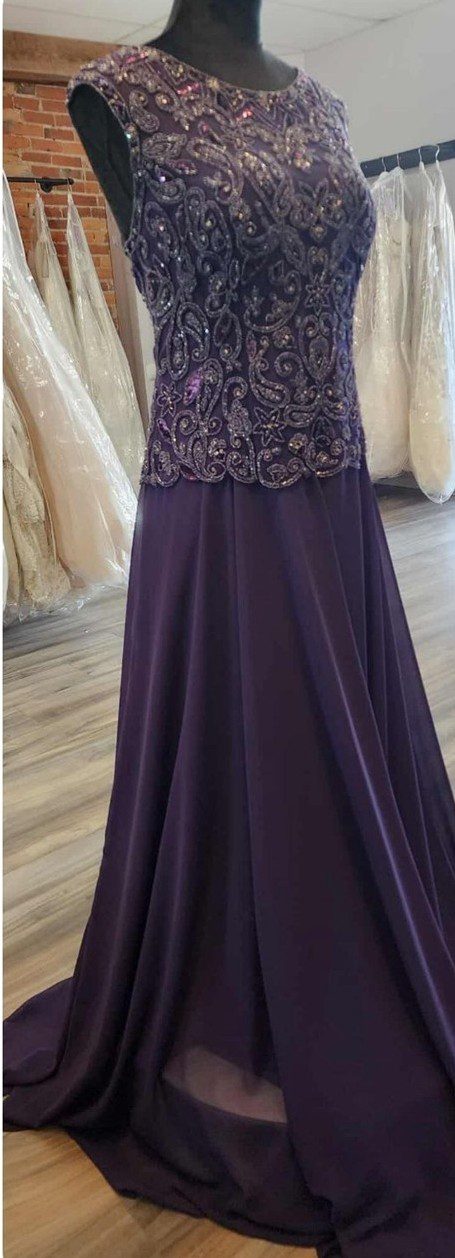 Elegant purple evening gown with lace bodice and flowing skirt.