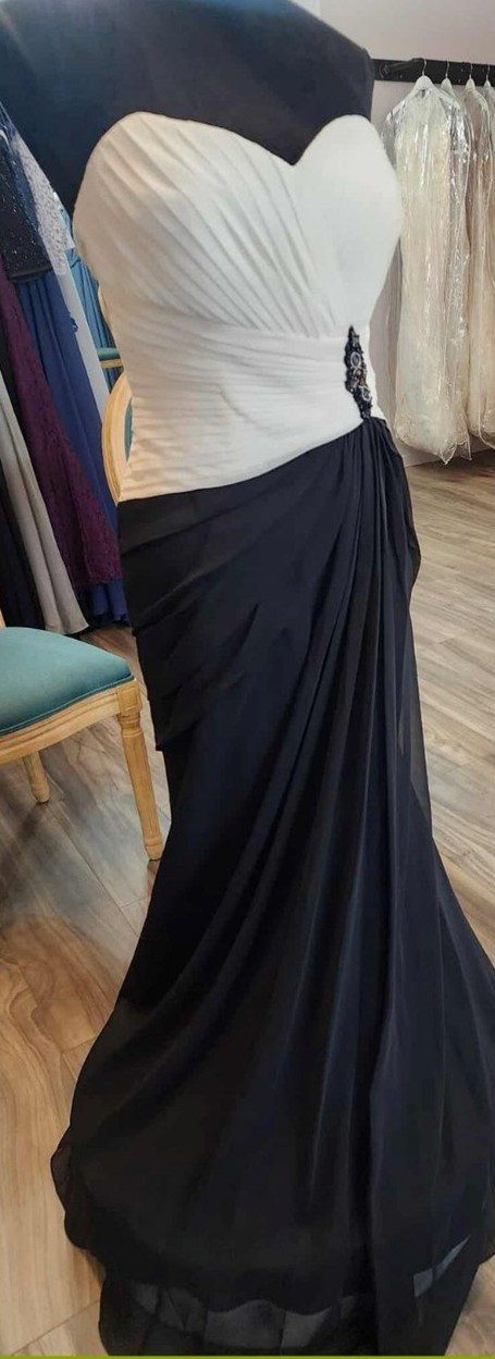 Elegant black draped saree flowing gracefully.