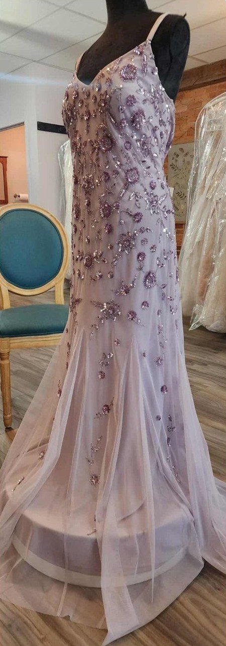 Elegant lavender gown with intricate floral embroidery and a flowing tulle skirt.
