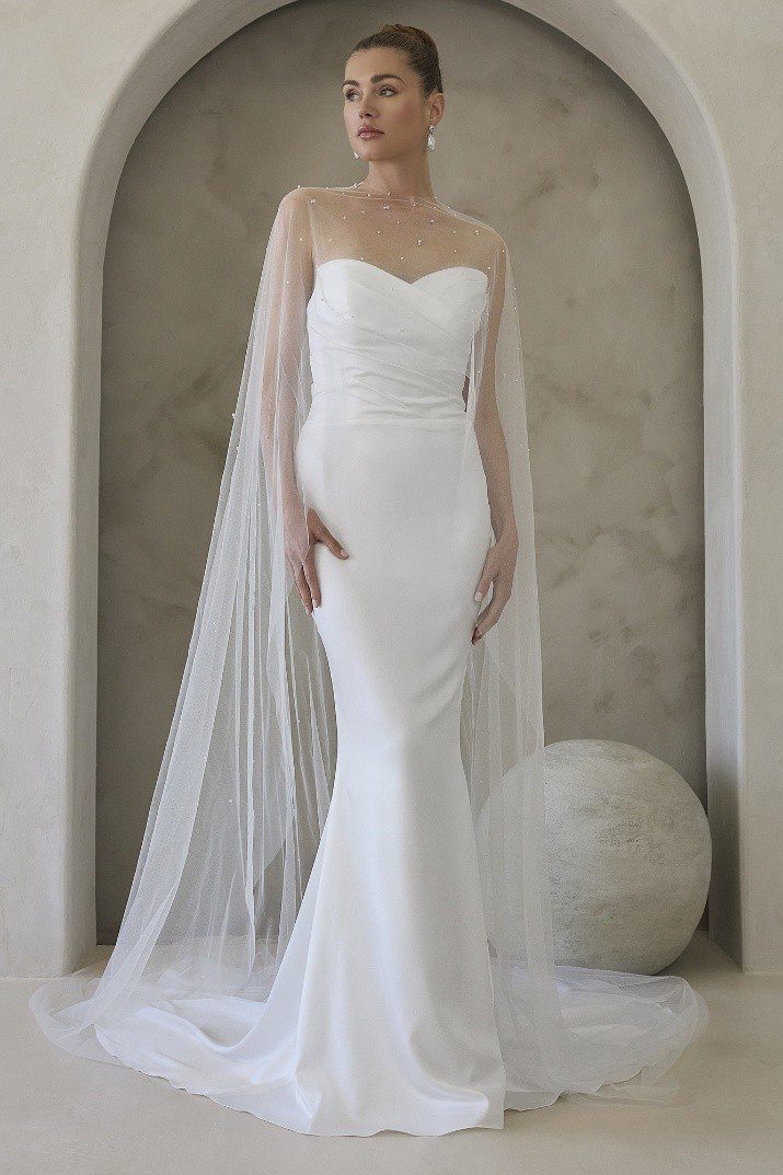 Elegant white mermaid wedding dress with a long veil.