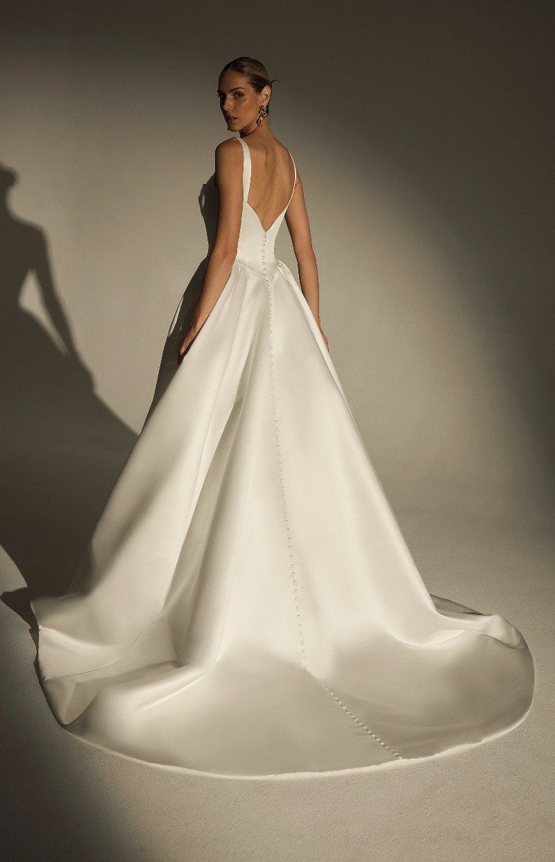 Elegant white satin gown with a dramatic train and open back.